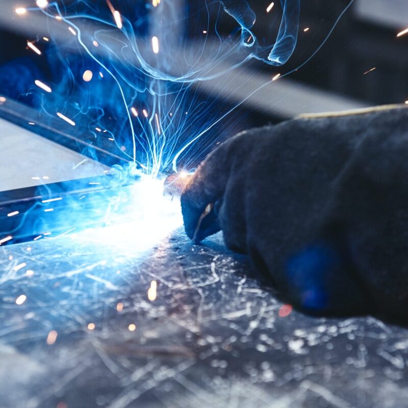 The better way to weld. Hand in glove hold welding steel. Welds with argon-arc welding